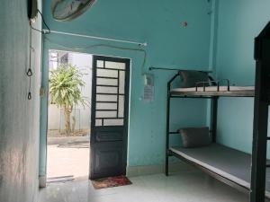 a room with two bunk beds and a doorway at Đức Phát Homestay in Tân Phú