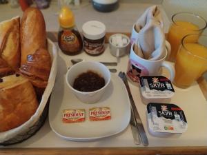 a table with a plate of bread and a bowl of food at Le Côte d'Azur in Toulon