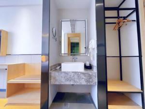 a bathroom with a sink and a mirror at GreenTree Inn Nanjing Baijiahu in Nanjing +277 photos