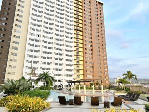 a large building with a table and chairs in front of it at Heart of CDO Scenic View in Cagayan de Oro