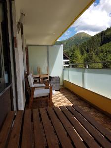 a balcony with a chair and a view of the mountains at Innerkrems Apartment Mateja in Innerkrems