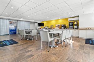 a dining room with tables and chairs and a counter at Microtel Inn and Suites - Salisbury in Salisbury