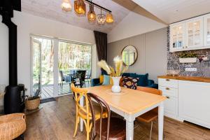 a kitchen and dining room with a table and chairs at Luxury Villa with Pine Forest View, Palanga in Palanga