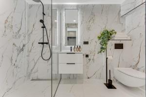 a bathroom with a shower and a toilet and a sink at Urban Heaven Luxury Lofts in Tallinn +81 photos