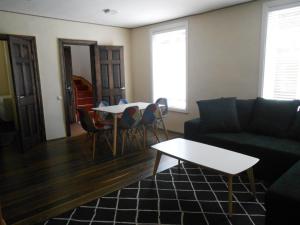 a living room with a couch and a table at Yellow Center Holiday Home in Pärnu