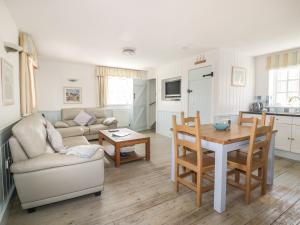 a living room with a couch and a table at Owls Roost in Saint Goran