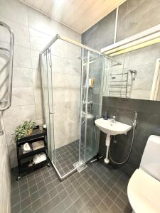 a bathroom with a shower and a sink at Midnight Sun center apartments in Sodankylä
