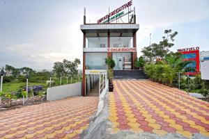 a building with a staircase in front of it at Omkar Executive Nagar Road in Loni Kand