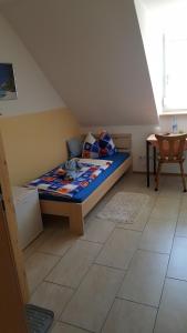 a small bedroom with a bed in a attic at Pension Assmann in Langenbruck