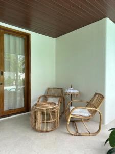 two wicker chairs and a table on a porch at Summa Villa - Tropical 2BR Villa w Big Pool in Selong Belanak