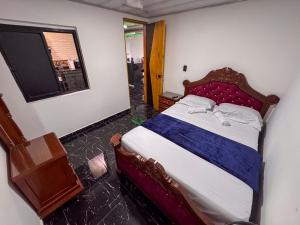 a bedroom with a bed in a room with a window at Habitacion con baño privado in Estación El Salto