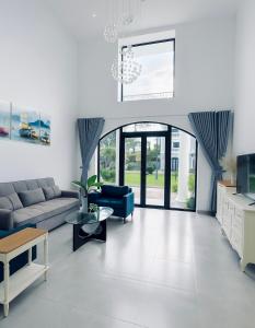 a living room with a couch and a table at Camly Chic Villa in Da Lat