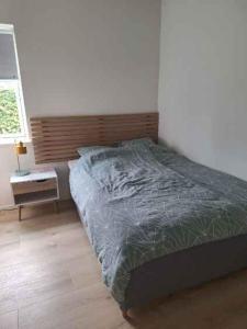 a bedroom with a bed and a desk and a window at Holiday Idyll With Nature And City Nearby in Skødstrup +6 photos