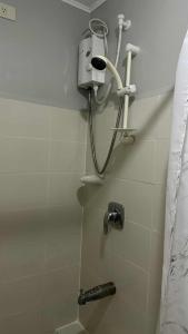 a shower in a bathroom with a shower head at 2BR Condo at Sanremo with Full Kitchen plus Free Fast&Unli Wi-Fi Complimentary Netflix plus Free Access to Pool in Cebu City