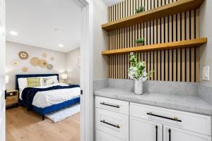 a bedroom with a bed and a vase of flowers on a counter at Xlnc Exotic home Rexview Dr in San Diego