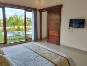 TV a/nebo společenská místnost v ubytování The Swasti Villa Ubud