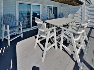 a white table and chairs on a deck at Put-in-Bay Waterfront Condo #202 in Put-in-Bay