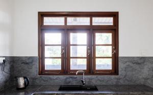 a kitchen with a sink and a window at Sakura Stays in Nawalapitiya