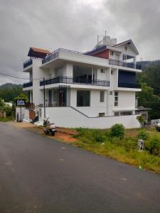 a large white building on the side of a road at Forest Abode in Yercaud