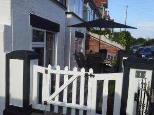 a white picket fence in front of a building at Westdene in Skegness +30 photos