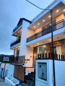 a white house with a door in front of it at Forest Abode in Yercaud