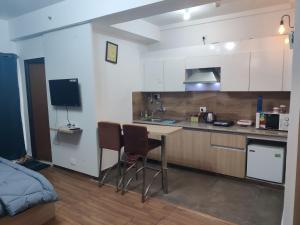 a kitchen with a sink and a table and chairs at Dristy homez in Noida