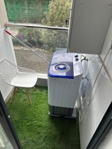 a trash can and a chair in front of a window at Golden mango heights in Nairobi