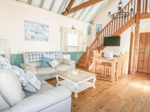 a living room with a couch and a table at Dovecote in Saint Goran