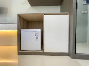 a white trash can in a shelf in a room at The Pavilion in Kanggraksan +26 photos