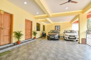 a garage with two cars parked in it at Fabhotel Baga Tulip - 500M From Baga Beach in Baga