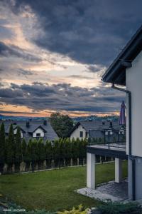 a view of a house from the porch of a house at DAJ SOBIE CZAS Apartament in Istebna