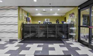 a store lobby with a checkout counter and yellow walls at Quality Inn Prattville I-65 in Prattville +134 photos