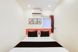 a bedroom with a bed in a room at Collection O Neredmet Road in Hyderabad