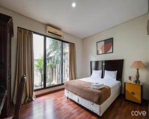 Ένα ή περισσότερα κρεβάτια σε δωμάτιο στο Cove Arimbi