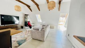 a living room with a couch and a flat screen tv at Ewelinas Loft in Sundern