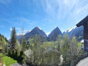 a view of the mountains from a house at Apartment in Neukirchen with a balcony in Neukirchen am Großvenediger +46 photos