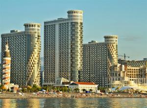 a view of a city with tall buildings and a beach at Sebi Apartment Batumi Towers in Batumi