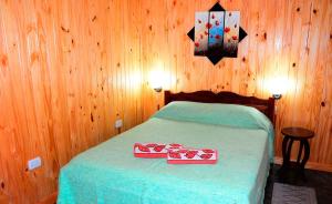 a bedroom with a bed with two boxes on it at Nuova Villa Cabañas in Puerto Iguazú