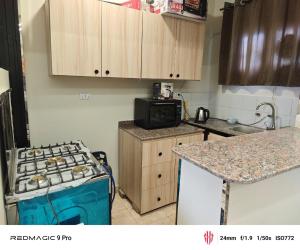 a kitchen with a stove and a counter top at فيلا علي in Sheikh Zayed