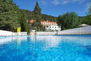 una gran piscina de agua azul frente a una valla blanca en Parador de Cazorla, en Cazorla