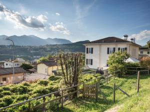 a house on a hill with mountains in the background at Locanda Del Conventino in Lugano