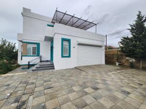 a white house with a garage at Дом in Baku