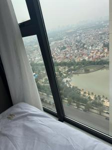 a bed in a room with a large window at Mas D3208 in Phú Thú +4 photos