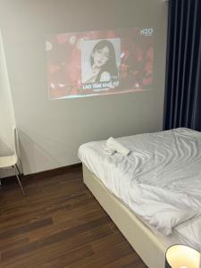 a bedroom with a bed with a poster on the wall at Mas D3208 in Phú Thú