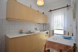 a kitchen with a table with a bowl on it at To Pithari in Skala Marion