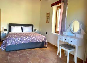 a bedroom with a bed and a dressing table and a mirror at Wild Tulip Escape in Kolymvari +47 photos