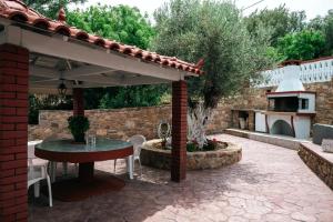 an outdoor patio with a table and a pavilion at Euphoria Retreat in Karfas