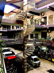 a spiral staircase in the middle of a building at Roopyal Hotel & Restaurant in Dargai