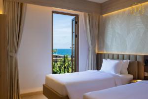 Ένα ή περισσότερα κρεβάτια σε δωμάτιο στο Blessed Hotel Phu Quoc