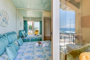 a bedroom with a blue bed and a mirror at Victoria Beach Apartments in Menton